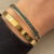 img_5163 Goudkleurige bangle armband met zwarte steentjes