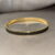 img_5381 Goudkleurige bangle armband met zwarte steentjes