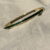 Goudkleurige dunne bangle armband met groene steentjes